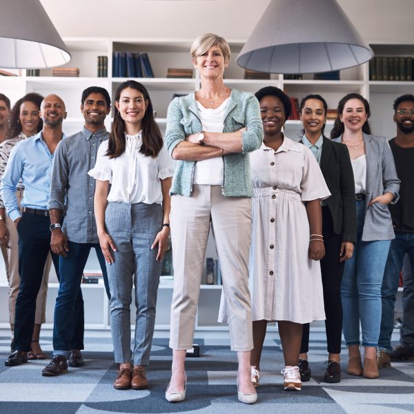 Portrait of a diverse group of businesspeople standing together in an office.